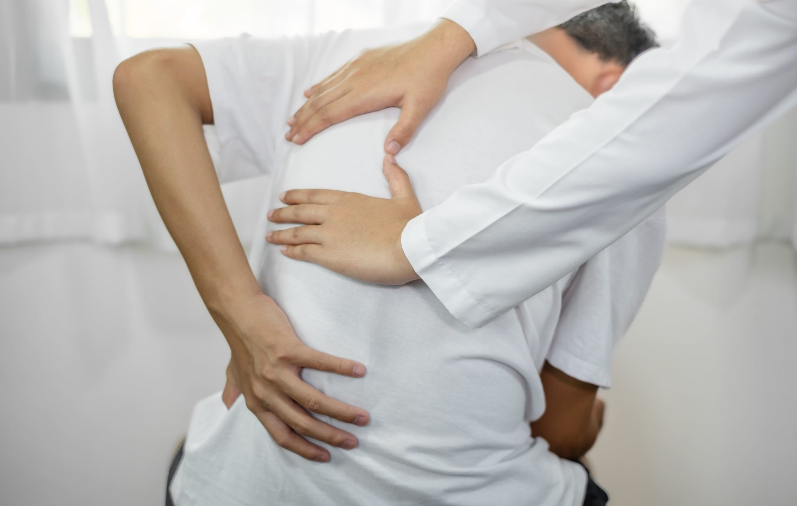 Female,Physiotherapists,Provide,Physical,Assistance,To,Male,Patients,With,Back